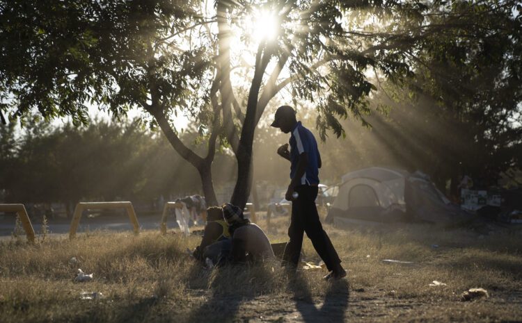 Migrants walk in a makeshift migrant camp in Braulio Fernandez Ecological Park in Ciudad Acuña, Mexico on September 22, 2021.